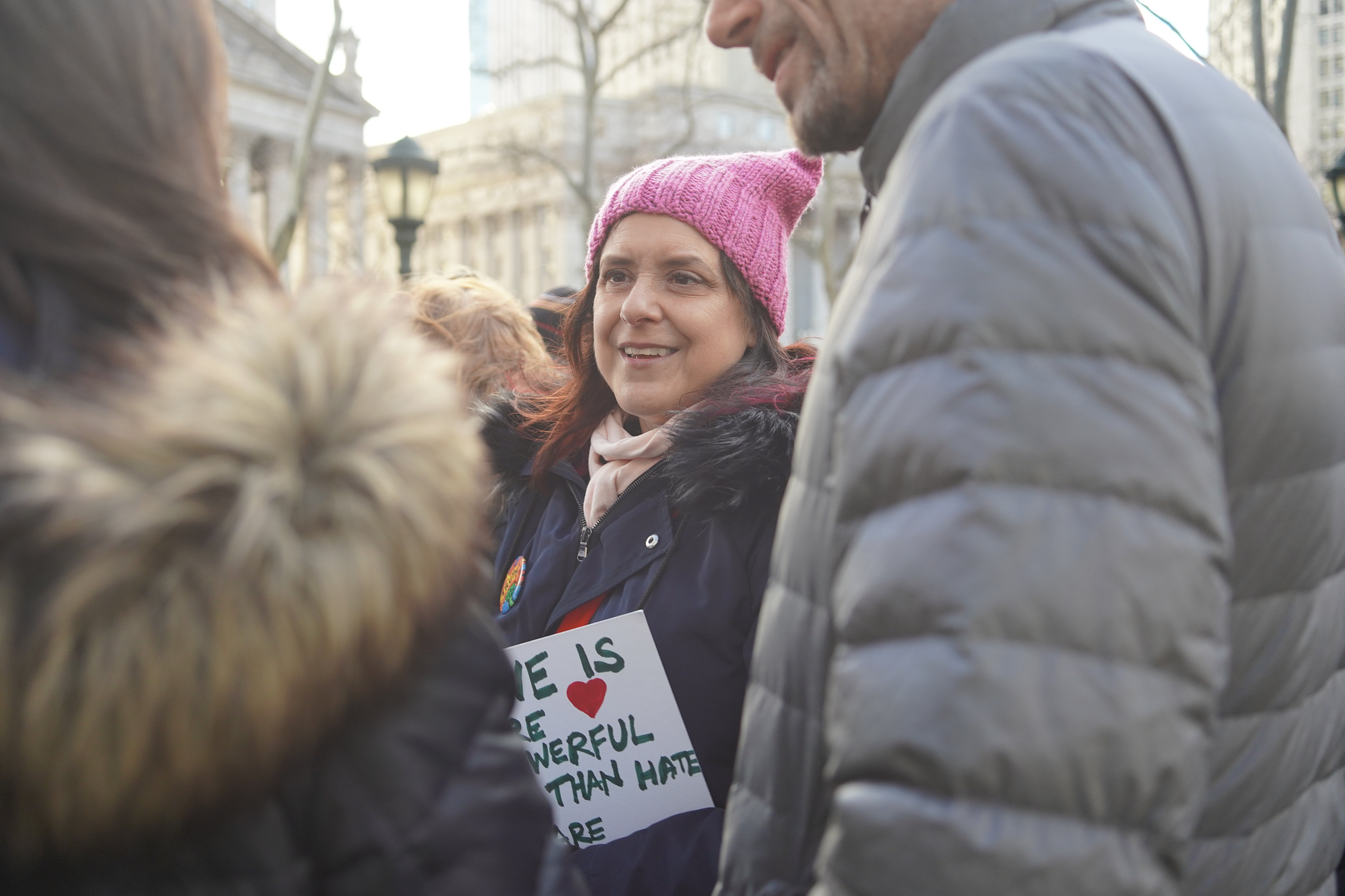woman with pink hat and sign